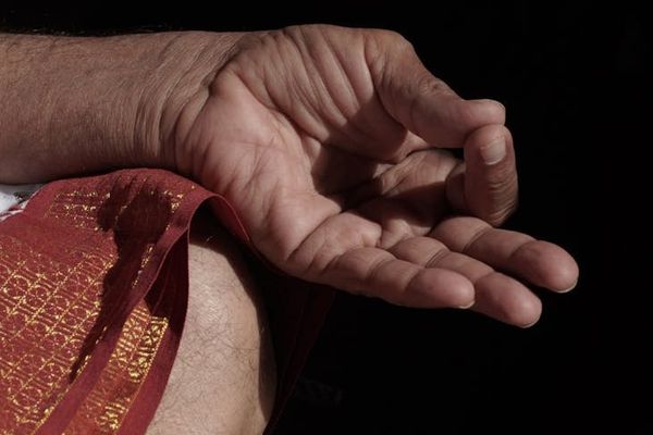 Close up of hands in mudra position during meditation